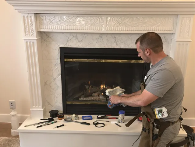 New London Chimney Sweep performing fireplace maintenance in New London, CT