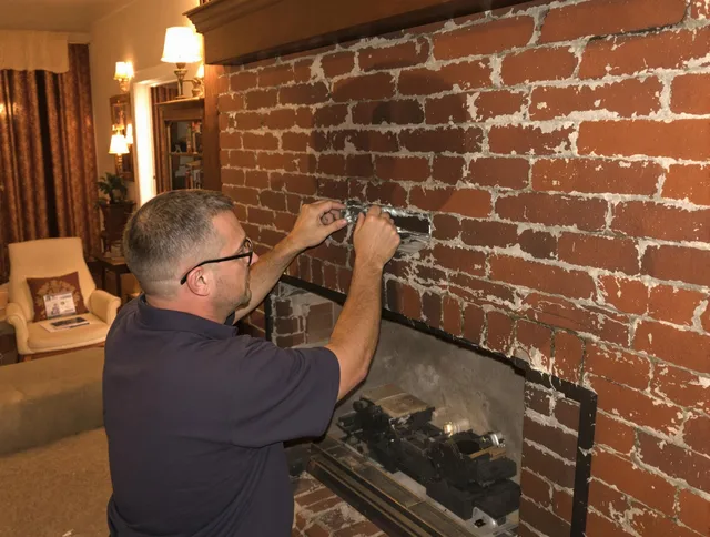 New London Chimney Sweep expert fixing a fireplace in New London, CT